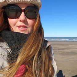 Portrait of woman wearing sunglasses at beach
