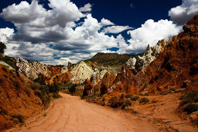 Road amidst rocks against sky