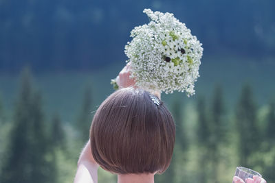 Rear view of bride holding bouquet during wedding ceremony