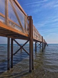 Pier over sea against sky