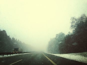 Road passing through foggy weather