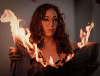 Portrait of young woman with fire