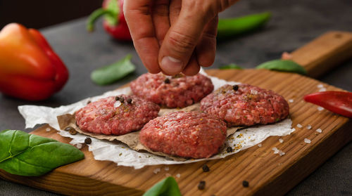 Close-up of person preparing food on cutting board