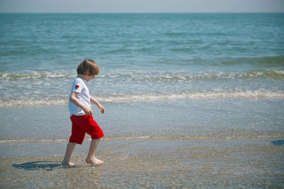 Full length of  boy on beach