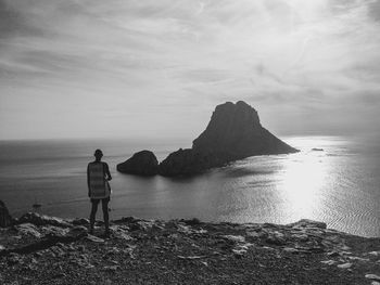 Man standing on beach against sky