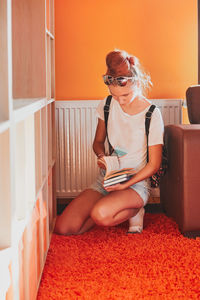 Woman sitting on sofa at home