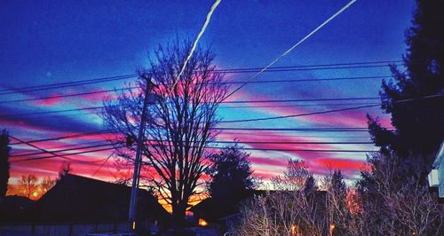 Low angle view of power lines against sky