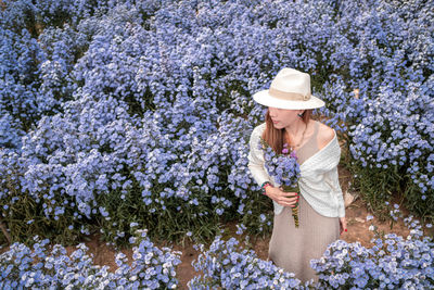 Full length of woman with pink flowers