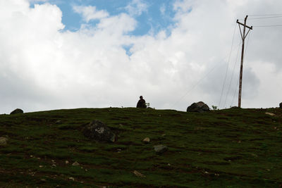 Low angle view of rocks on field against sky