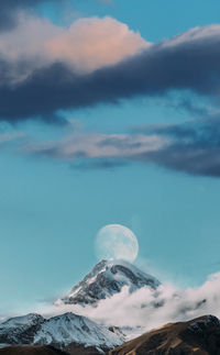 Low angle view of snowcapped mountains against sky