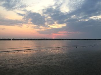 Scenic view of beach against sky during sunset