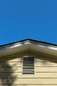 Low angle view of building against clear blue sky