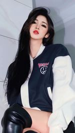 Portrait of young woman sitting on sofa at home