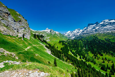 Scenic view of mountains against clear blue sky