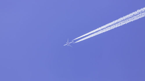 Low angle view of airplane flying in sky