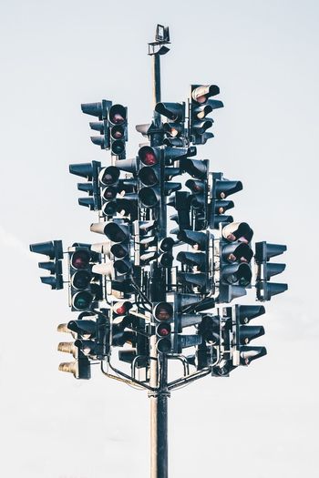 Low angle view of road signals against clear sky