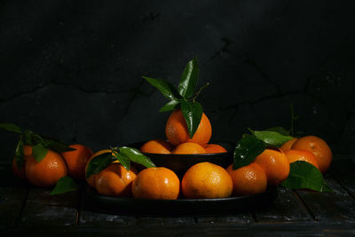 Close-up of orange fruits against black background