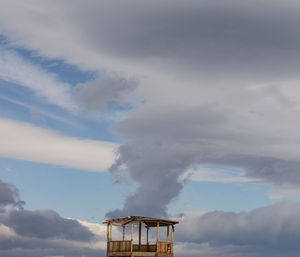 Low angle view of smoke stack against sky