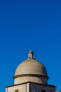 Low angle view of bell tower against clear blue sky