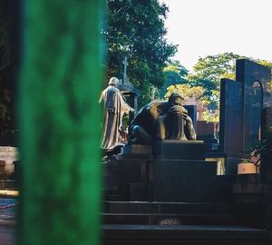 Rear view of statue against trees