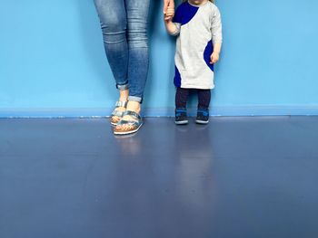 Low section of woman standing on tiled floor