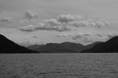 Scenic view of sea and mountains against sky