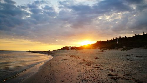 Scenic view of beach against sky during sunset