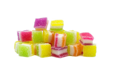 Close-up of multi colored candies against white background