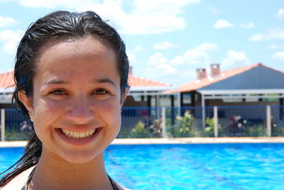 Portrait of smiling young woman in swimming pool