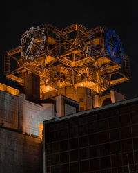 Low angle view of illuminated building against sky at night