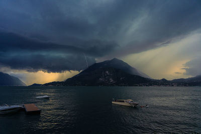 Scenic view of sea and mountains against sky