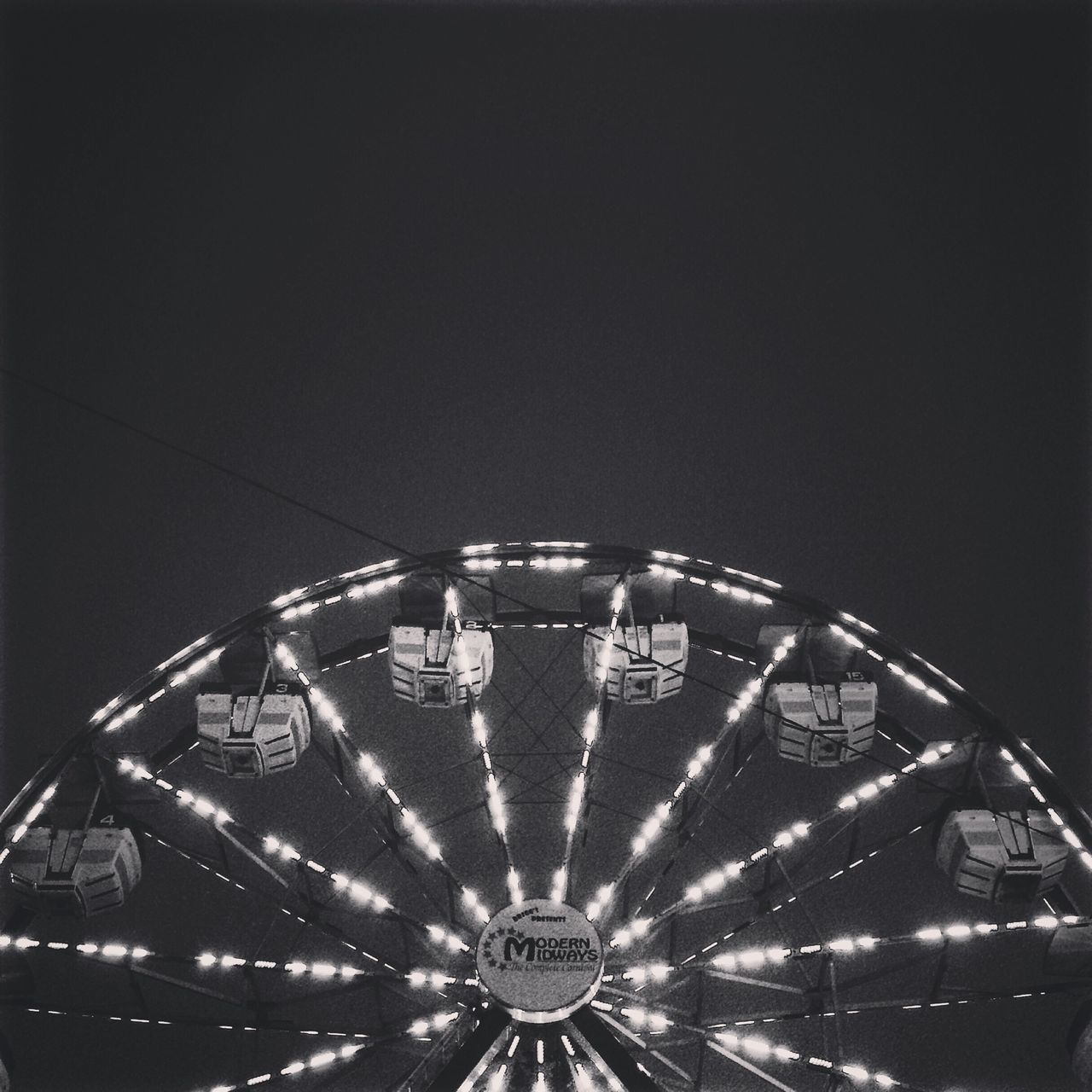 transportation, clear sky, night, ferris wheel, copy space, amusement park, illuminated, arts culture and entertainment, mode of transport, wheel, low angle view, amusement park ride, land vehicle, architecture, built structure, no people, outdoors, travel, time, circle
