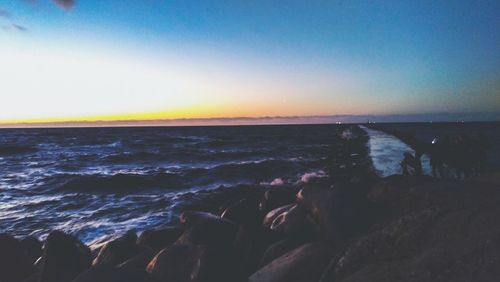 Scenic view of sea against clear sky during sunset