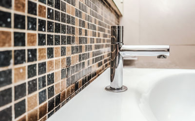 Close-up of faucet in bathroom