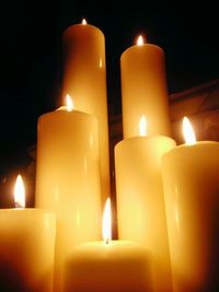 Close-up of lit candle in dark room