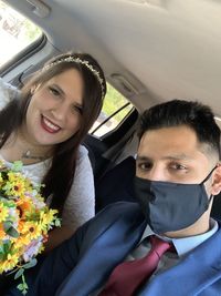 Portrait of smiling young woman sitting in car