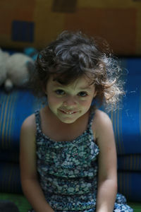 Portrait of smiling girl playing at home