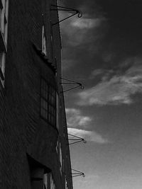 Low angle view of building against cloudy sky