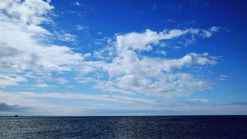 Scenic view of sea against cloudy sky