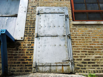 Low angle view of closed metallic door of old building