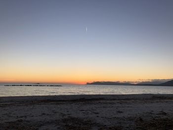 Scenic view of sea against clear sky during sunset