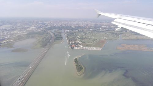 Cropped image of airplane flying over sea