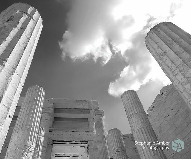 LOW ANGLE VIEW OF SKYSCRAPERS AGAINST CLOUDY SKY