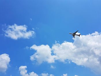 Low angle view of airplane flying in sky