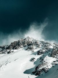 Scenic view of snow covered mountains against sky