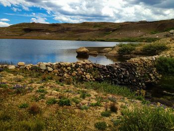 Scenic view of lake against cloudy sky