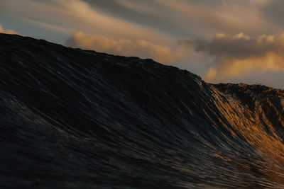 Texture of a wave reflected by the sunrise colors.