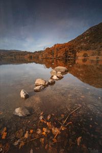 Scenic view of lake against sky during sunset