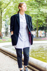 Full length of young woman standing outdoors