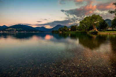Scenic view of lake against sky during sunset